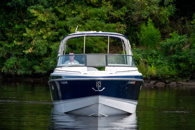 Slide: The Image of 2008 Formula 310 Bowrider cruising on a calm river with lush green background. - 10