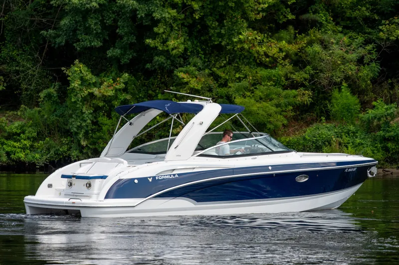 Slide: The Image of 2008 Formula 310 Bowrider cruising on a calm river with lush green trees. - 3