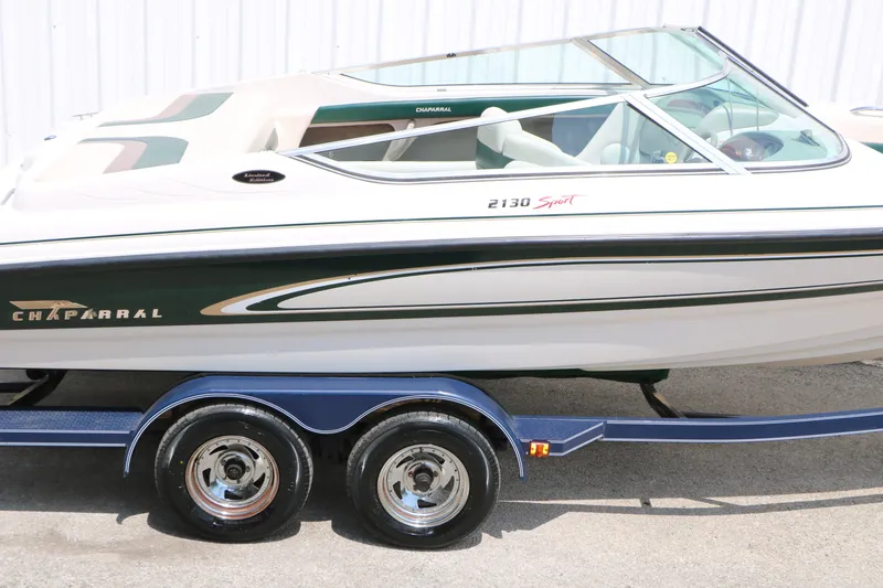 Slide: The Image of 1997 Chaparral 2130 SS boat on trailer, side view, white and green design. - 15