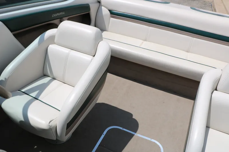 Slide: The Image of Interior of a 1997 Chaparral 2130 SS boat with white seating and teal accents. - 31