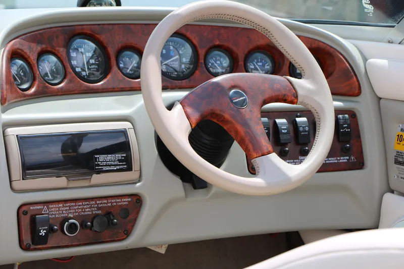 Slide: The Image of Dashboard of a 1997 Chaparral 2130 SS boat with wood accents and gauges. - 37