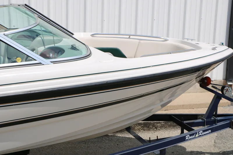 Slide: The Image of 1997 Chaparral 2130 SS boat on trailer, white with black trim, parked outdoors. - 14