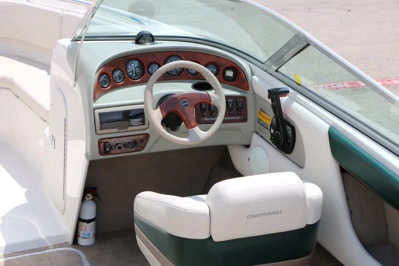 Slide: The Image of Interior of a 1997 Chaparral 2130 SS boat, featuring steering wheel and dashboard controls. - 20