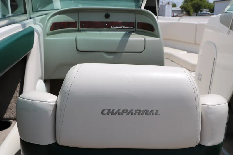 Slide: The Image of 1997 Chaparral 2130 SS boat interior with white leather seating and dashboard view. - 39