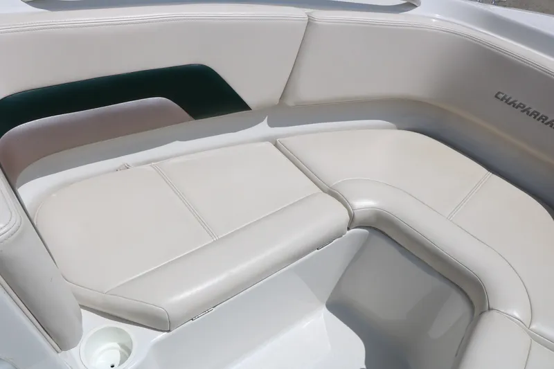 Slide: The Image of Interior seating of a 1997 Chaparral 2130 SS boat, featuring cream-colored upholstery. - 27