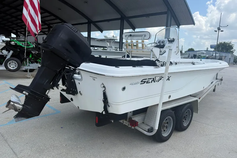 Slide: The Image of 2004 Sea Fox 225 Bay Fisher boat on trailer, parked under a canopy. - 7