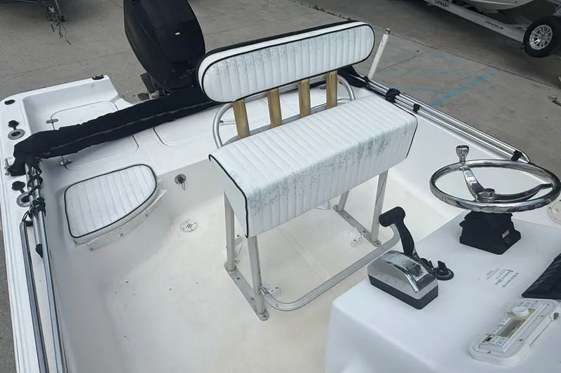 Slide: The Image of 2004 Sea Fox 225 Bay Fisher boat interior with steering wheel and seating. - 12