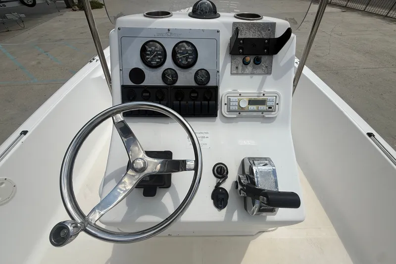 Slide: The Image of 2004 Sea Fox 225 Bay Fisher boat console with steering wheel and control panel. - 14