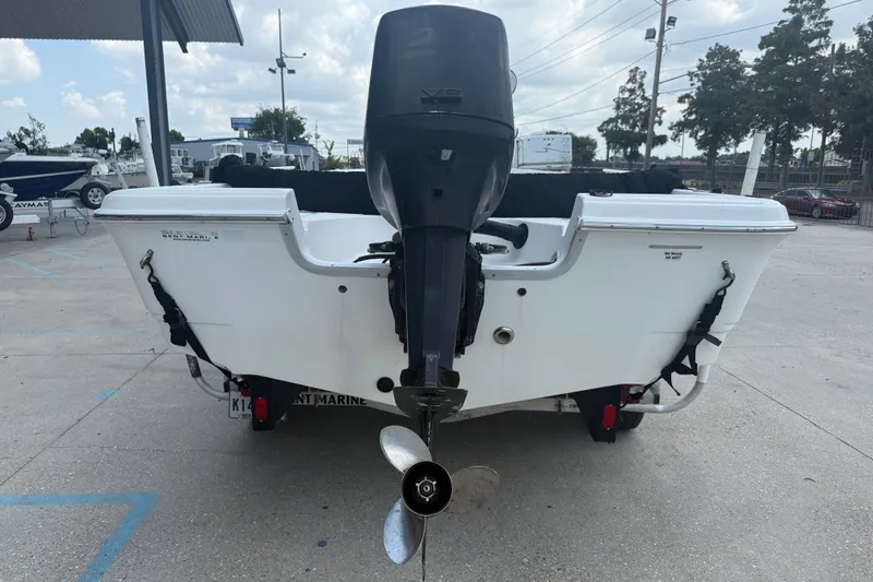 Slide: The Image of 2004 Sea Fox 225 Bay Fisher boat rear view with outboard motor in a marina. - 6