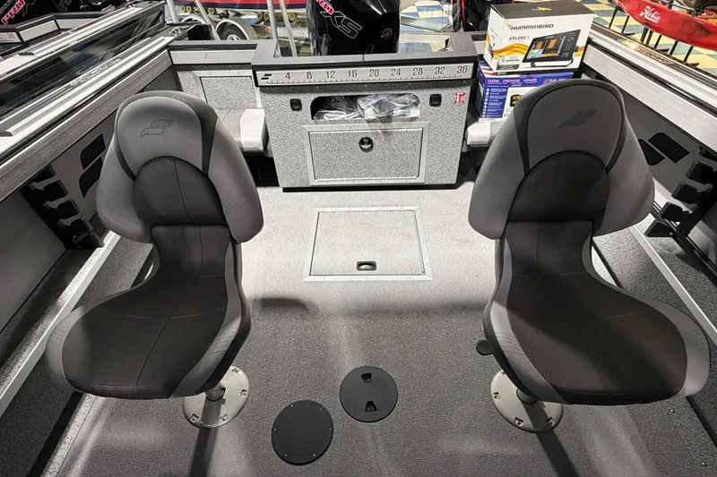 Slide: The Image of Interior of 2027 Starcraft Fishmaster 210 boat with two black seats and storage compartments. - 16