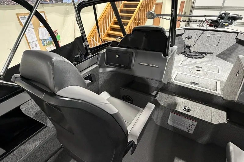Slide: The Image of Interior of 2027 Starcraft Fishmaster 210 boat with seating and control panel. - 15