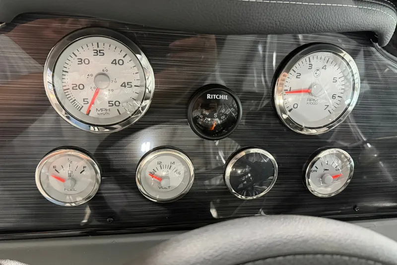 Slide: The Image of Dashboard of 2027 Starcraft Fishmaster 210 with speedometer, tachometer, and fuel gauges. - 9
