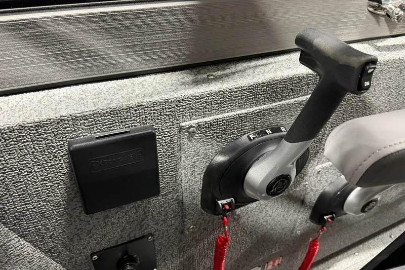 Slide: The Image of Control panel of 2027 Starcraft Fishmaster 210 boat with throttle lever and switches. - 12