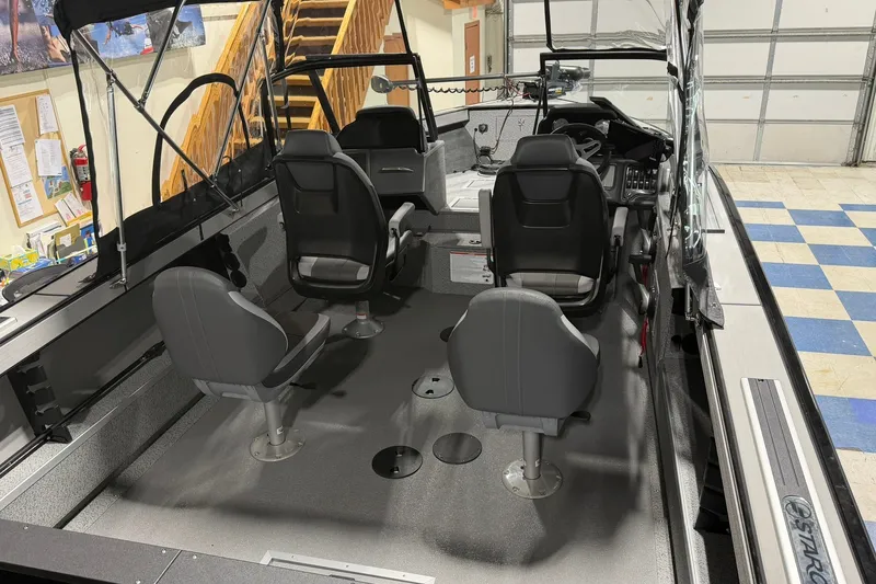 Slide: The Image of Interior of a 2027 Starcraft Fishmaster 210 boat with seating and controls. - 4