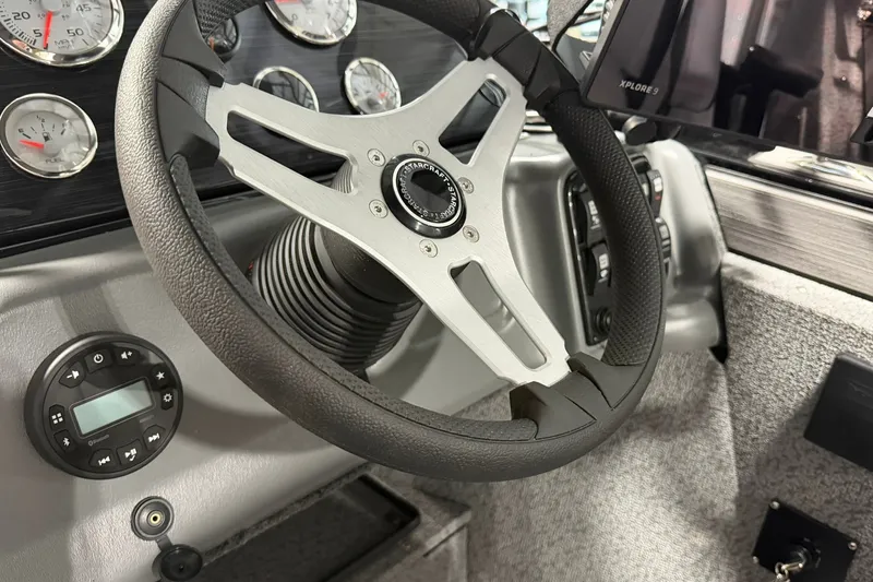 Slide: The Image of Steering wheel and dashboard of 2027 Starcraft Fishmaster 210 boat. - 10
