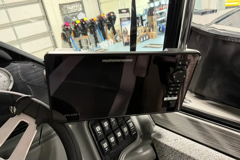 Slide: The Image of 2027 Starcraft Fishmaster 210 dashboard with Humminbird Xplore 9 display and control panel. - 13