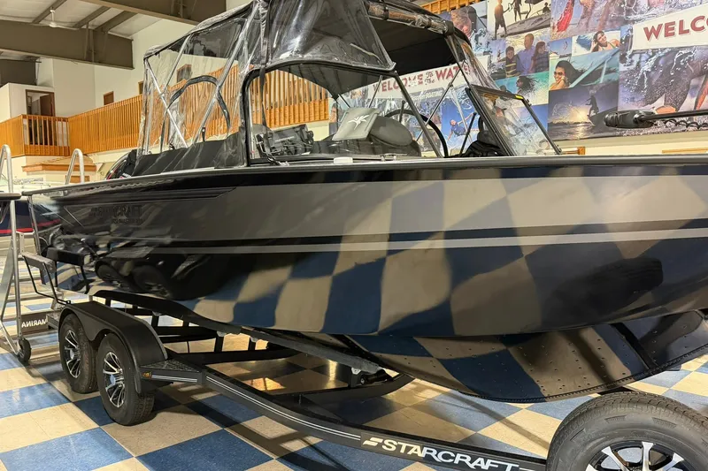 Slide: The Image of 2027 Starcraft Fishmaster 210 boat on trailer in showroom setting. - 3