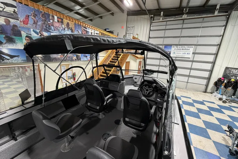Slide: The Image of Interior view of a 2027 Starcraft Fishmaster 210 boat in a showroom. - 17