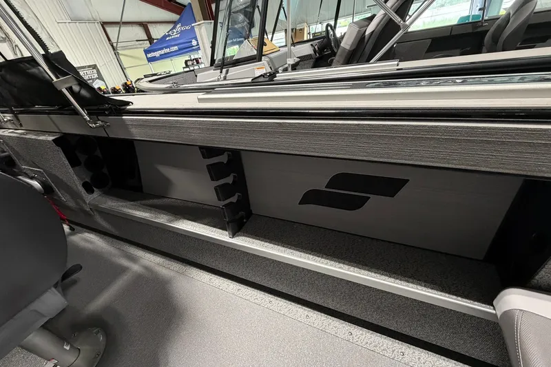 Slide: The Image of 2027 Starcraft Fishmaster 210 interior with rod storage and sleek design. - 18