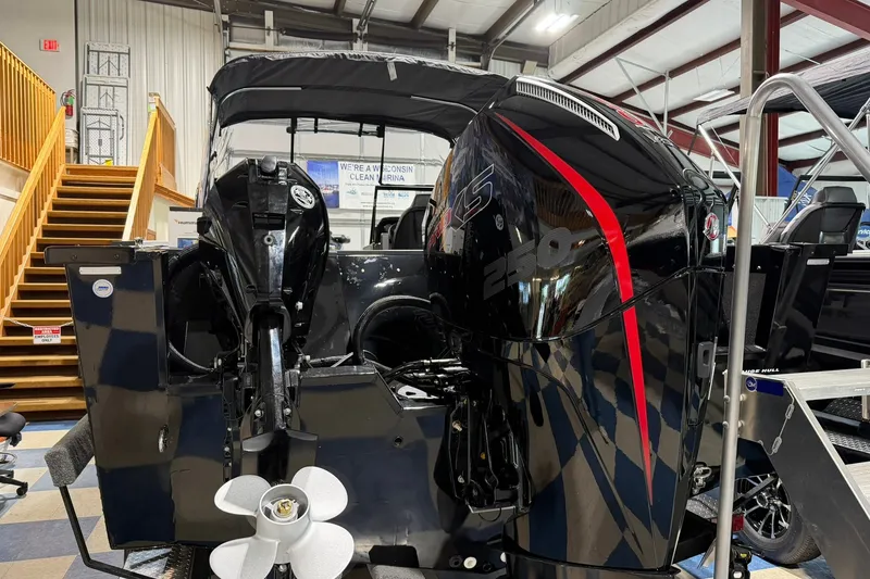 Slide: The Image of 2027 Starcraft Fishmaster 210 boat with powerful dual outboard motors in showroom. - 6