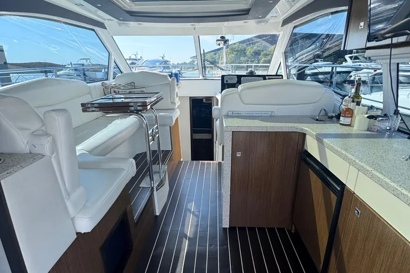 Slide: The Image of Luxurious interior of 2012 Cruisers Yachts 41 Cantius with modern seating and kitchenette. - 14