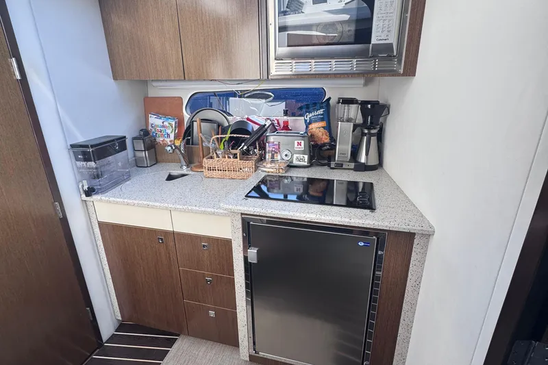 Slide: The Image of Compact kitchen in 2012 Cruisers Yachts 41 Cantius with modern appliances and storage. - 25