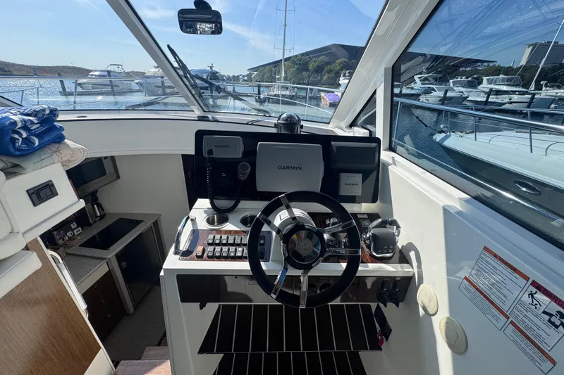 Slide: The Image of 2012 Cruisers Yachts 41 Cantius helm with Garmin navigation, docked in marina. - 13