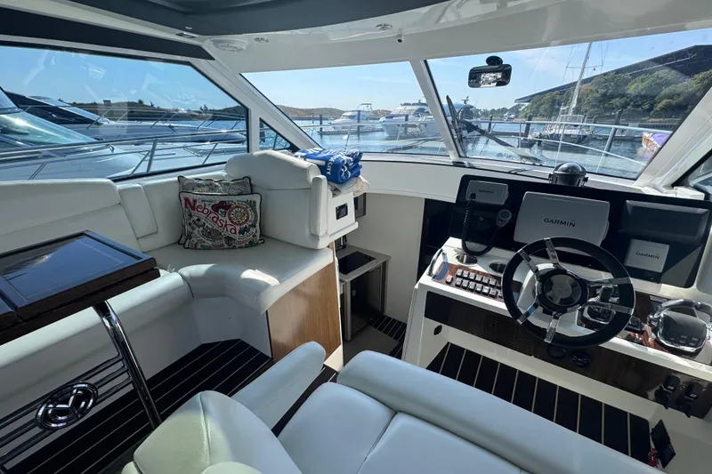 Slide: The Image of Luxurious 2012 Cruisers Yachts 41 Cantius helm with modern navigation equipment and plush seating. - 20