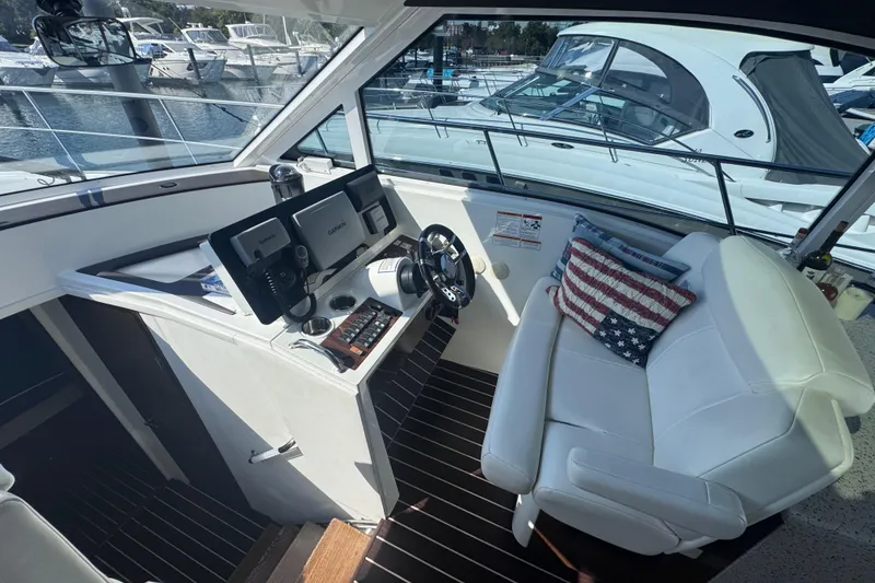 Slide: The Image of 2012 Cruisers Yachts 41 Cantius helm with white seating and American flag pillow. - 19