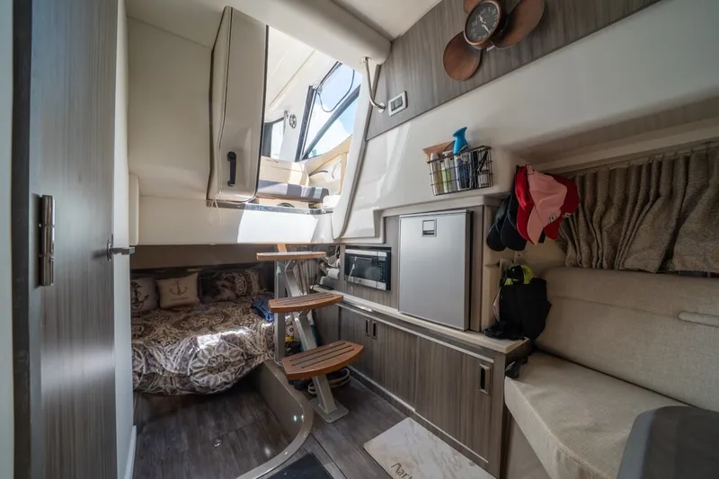 Slide: The Image of Interior of 2025 Sea Ray Sundancer 320 Outboard, featuring cozy cabin and modern amenities. - 22