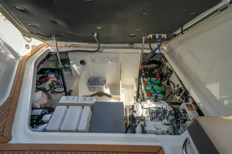 Slide: The Image of Engine compartment of 2025 Sea Ray Sundancer 320 Outboard, showcasing batteries and wiring. - 27