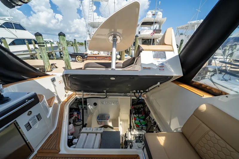 Slide: The Image of 2025 Sea Ray Sundancer 320 Outboard interior with open engine compartment at marina. - 26