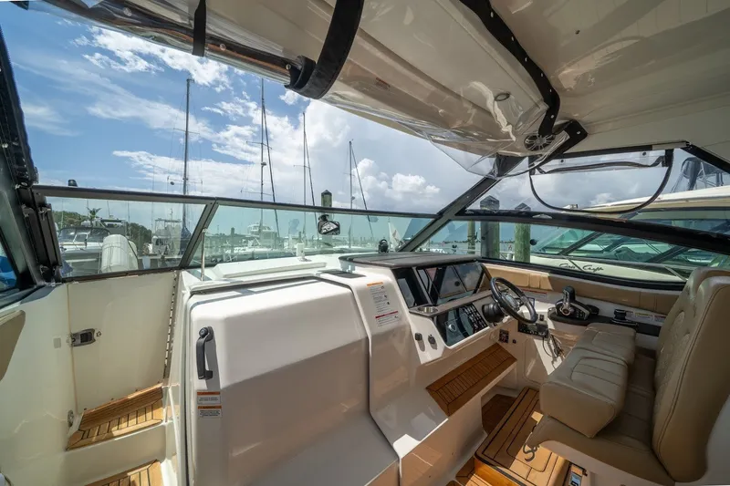 Slide: The Image of 2025 Sea Ray Sundancer 320 Outboard cockpit with luxurious seating and modern controls. - 18