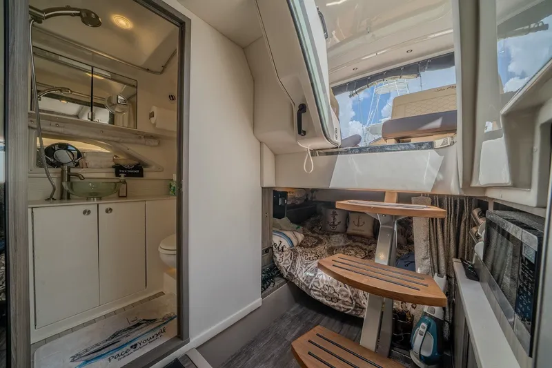 Slide: The Image of Interior of 2025 Sea Ray Sundancer 320 Outboard, featuring cozy cabin and modern amenities. - 21