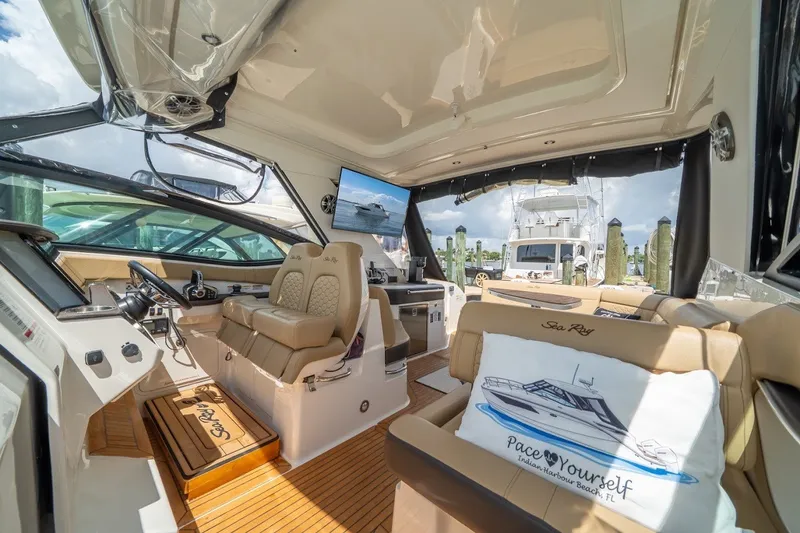 Slide: The Image of Interior of 2025 Sea Ray Sundancer 320 Outboard, featuring luxurious seating and modern controls. - 13