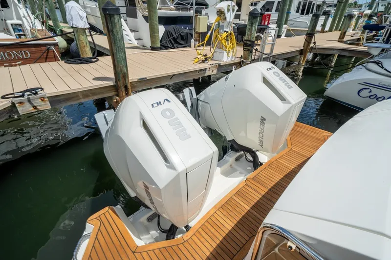 Slide: The Image of 2025 Sea Ray Sundancer 320 Outboard with twin Mercury engines docked at marina. - 30