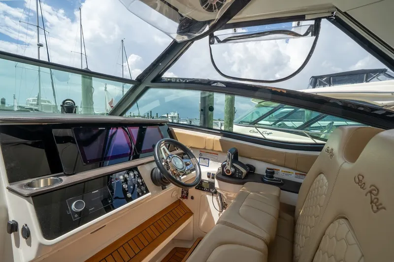 Slide: The Image of 2025 Sea Ray Sundancer 320 Outboard cockpit with modern controls and luxurious seating. - 14