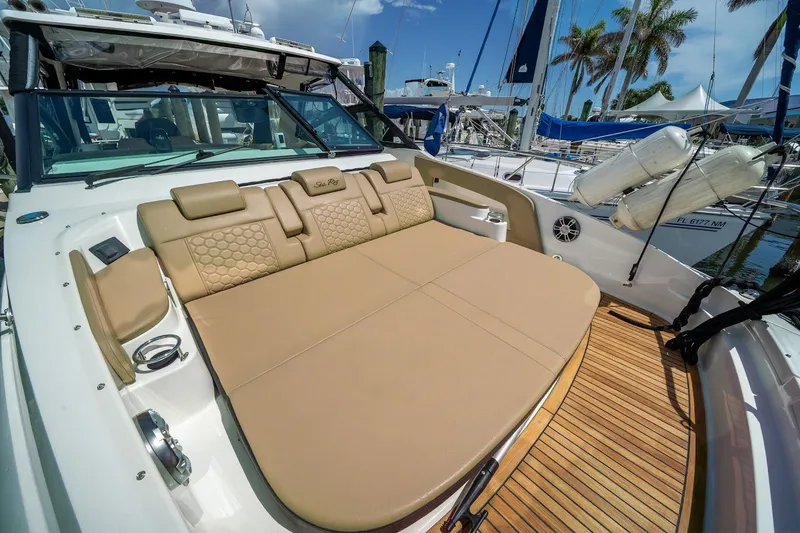 Slide: The Image of 2025 Sea Ray Sundancer 320 Outboard with luxurious sunbed and teak deck, docked at marina. - 20