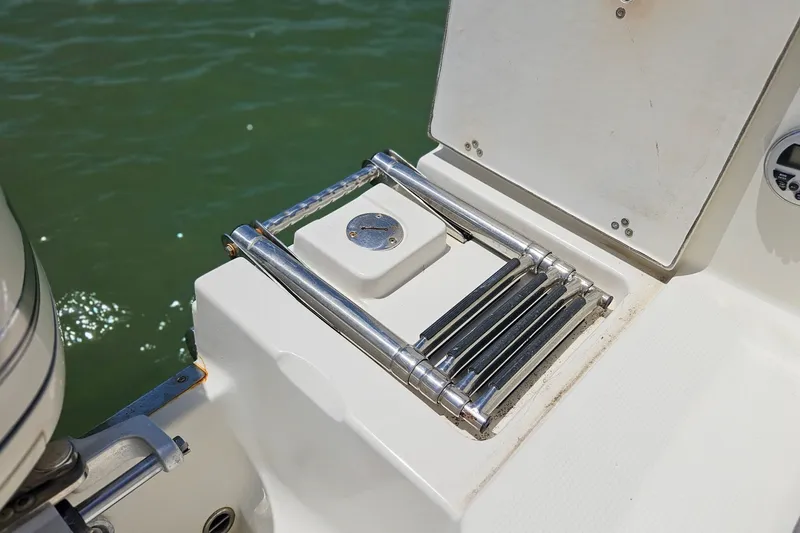 Slide: The Image of Stainless steel boat ladder on 2014 Sailfish 320 CC, near water. - 21