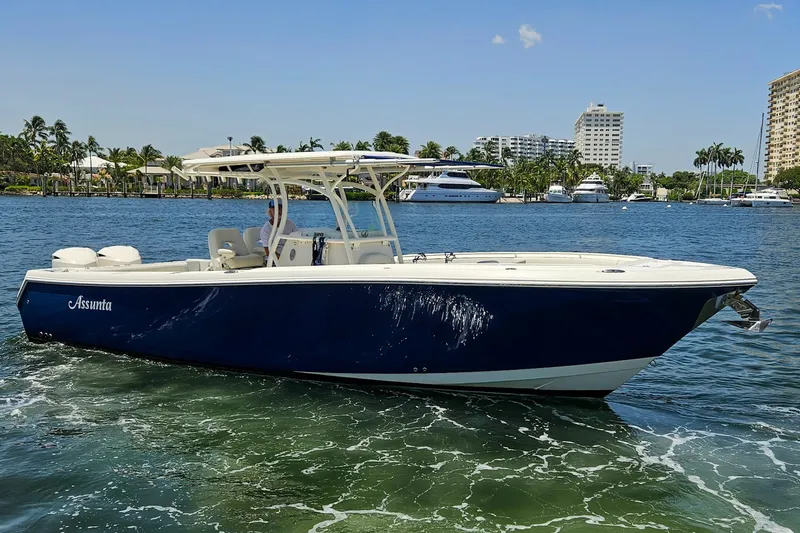 The Image of 2014 Sailfish 320 CC boat cruising on a sunny day near a marina. - 1