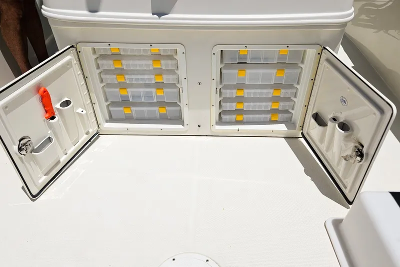 Slide: The Image of Storage compartments on a 2014 Sailfish 320 CC boat, featuring organized tackle boxes. - 18