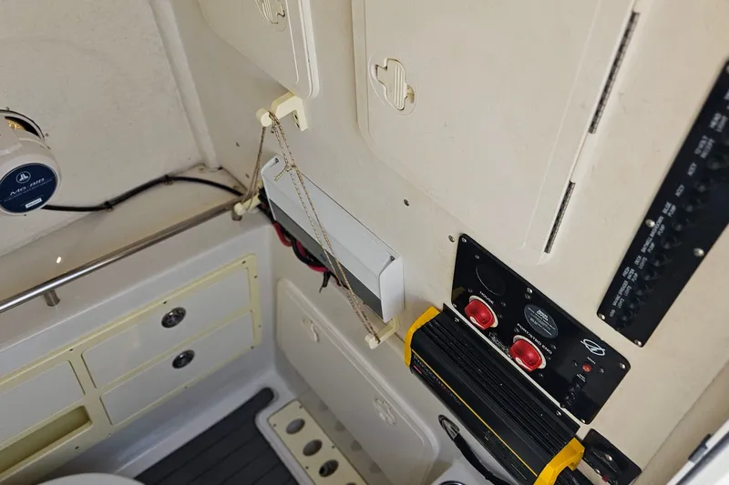 Slide: The Image of Interior view of a 2014 Sailfish 320 CC boat, showcasing control panels and storage compartments. - 25