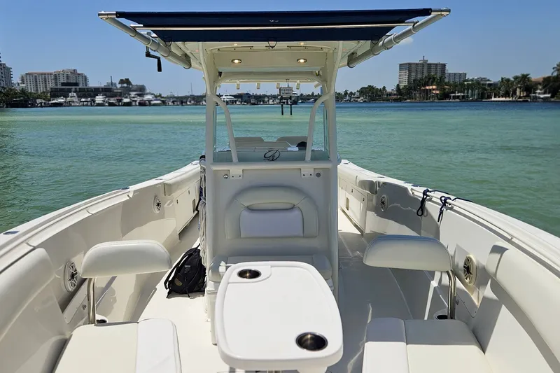 Slide: The Image of 2014 Sailfish 320 CC boat interior with seating, table, and ocean view. - 26