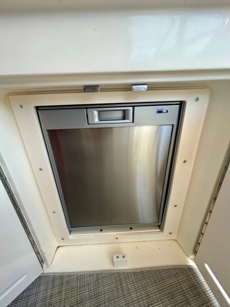 Slide: The Image of A built-in stainless steel refrigerator on a boat, surrounded by a white frame. - 14