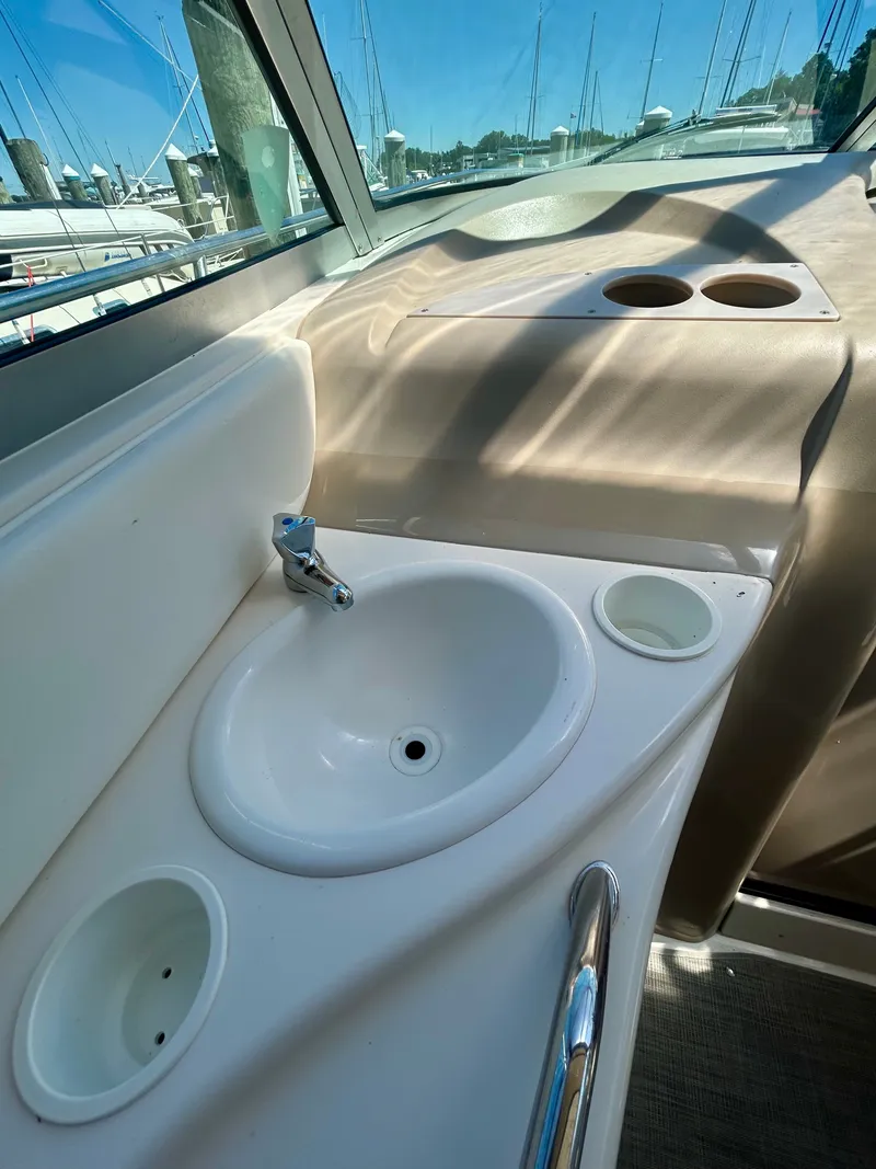 Slide: The Image of The image shows the cockpit of a 1999 Sea Ray 340 Sundancer with a sink and fixtures. - 26