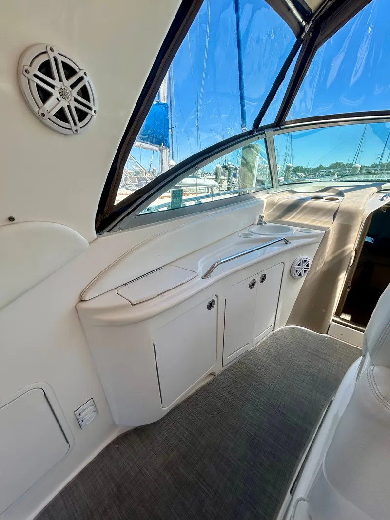 Slide: The Image of The image shows the cockpit of a 1999 Sea Ray 340 Sundancer with white seating and blue windows. - 13