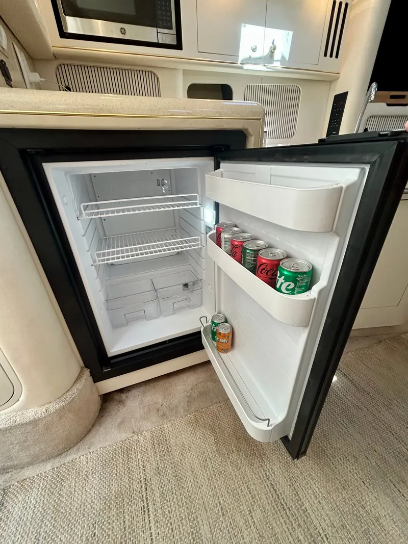 Slide: The Image of An open fridge in a boat galley with beverage cans in the door. - 18