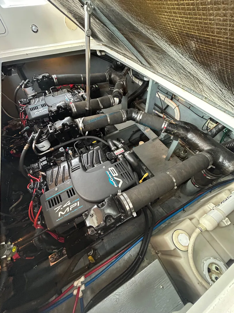 Slide: The Image of The engine room of a 1999 Sea Ray 340 Sundancer with two powerful engines and piping. - 31