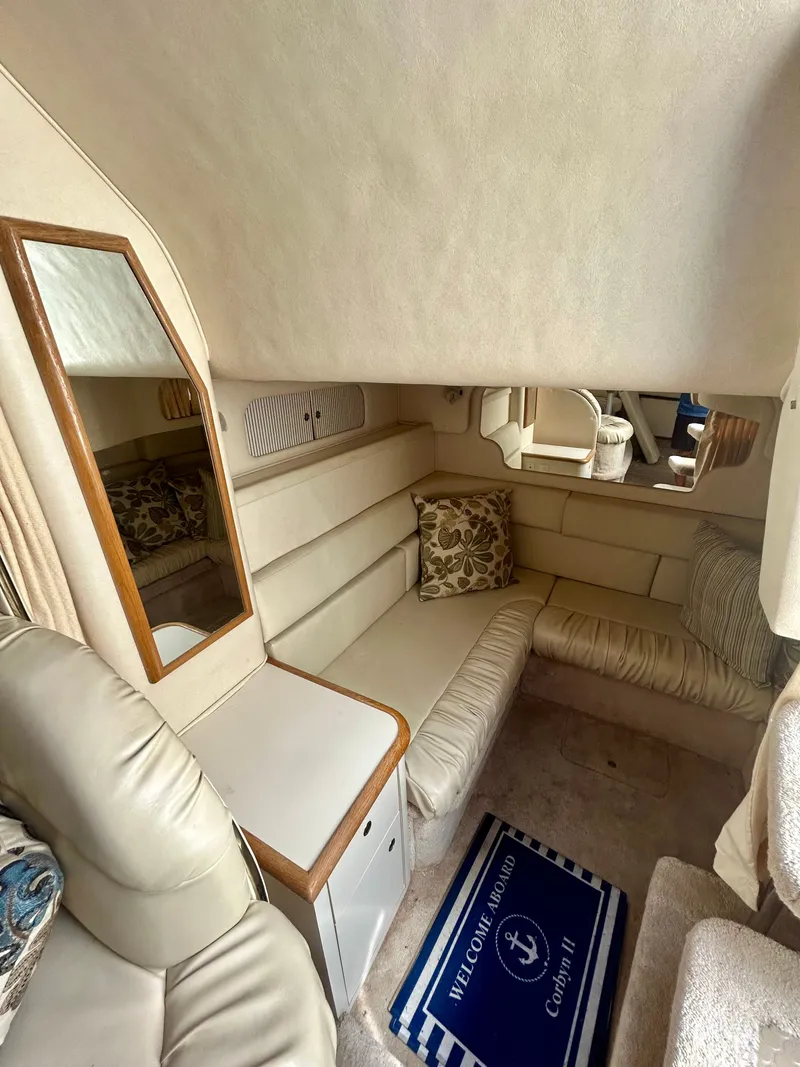 Slide: The Image of Interior of the 1999 Sea Ray 340 Sundancer with beige upholstery and a mirror. - 20