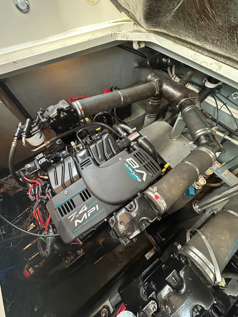 Slide: The Image of The engine compartment of a 1999 Sea Ray 340 Sundancer with a 7.4 MPI engine. - 28